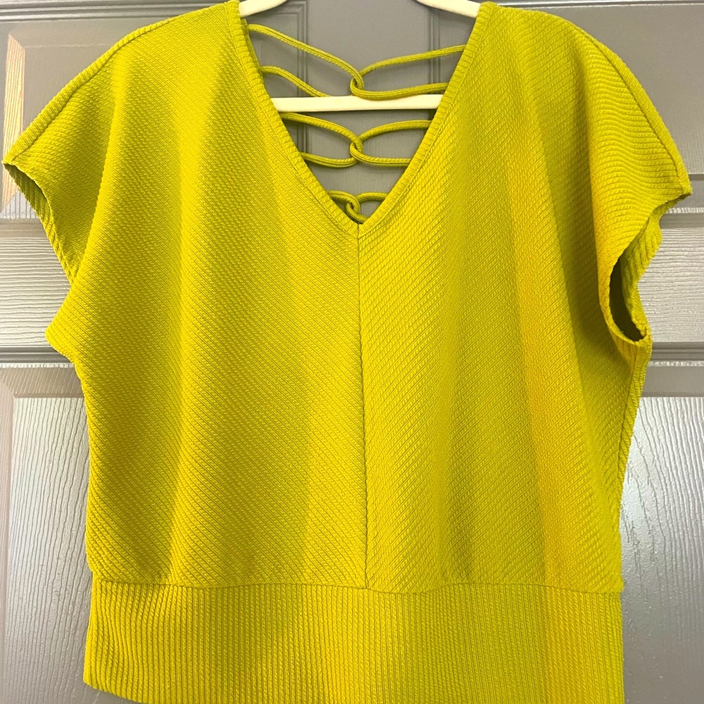Short sleeve top with lattice detail in back. Perfect for spring and summer!
